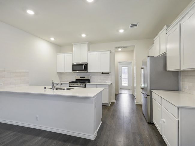 Kitchen with stainless steel appliances, backsplash, a peninsula, dark wood-style flooring, and recessed lighting | Image 8
