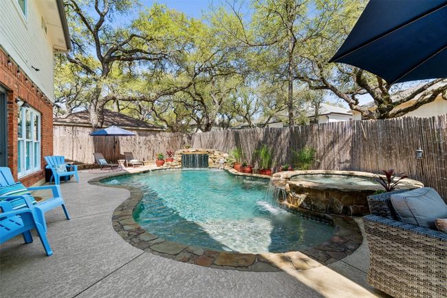 View of pool with a fenced backyard, a pool with connected hot tub, and a patio | Image 33
