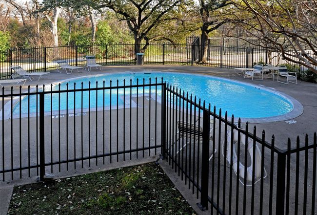 View of community swimming pool featuring a patio at rear of the building | Image 37