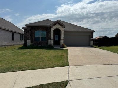 View of front facade with a front lawn and a garage | Image 1