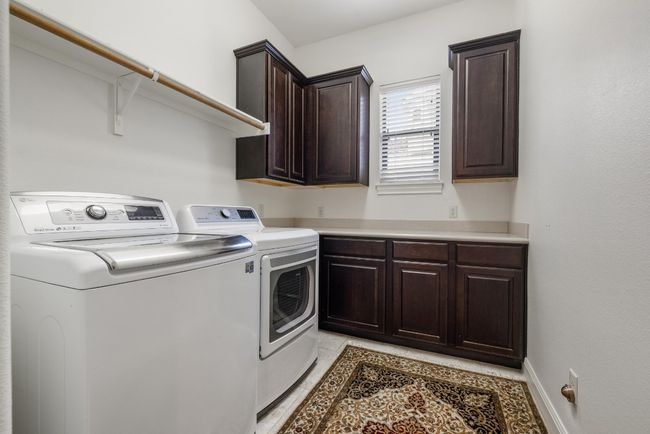 Washroom featuring washer and dryer and cabinet space | Image 27