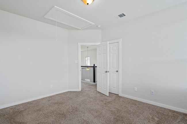 Empty room with attic access and carpet floors | Image 32