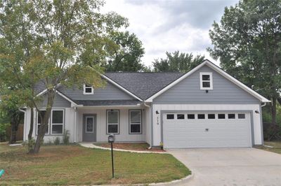 View of front of house with a garage and a front lawn | Image 1