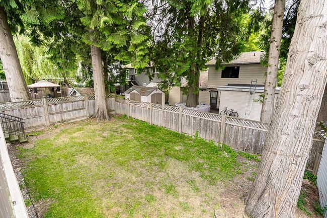 Fenced backyard with a storage unit | Image 33