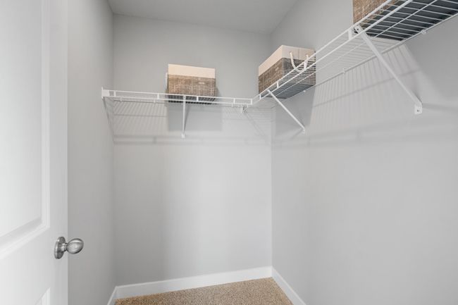 Each of the spacious secondary bedrooms feature well thought out window locations and a walk-in closet. Model photo. Options and colors will vary. | Image 23