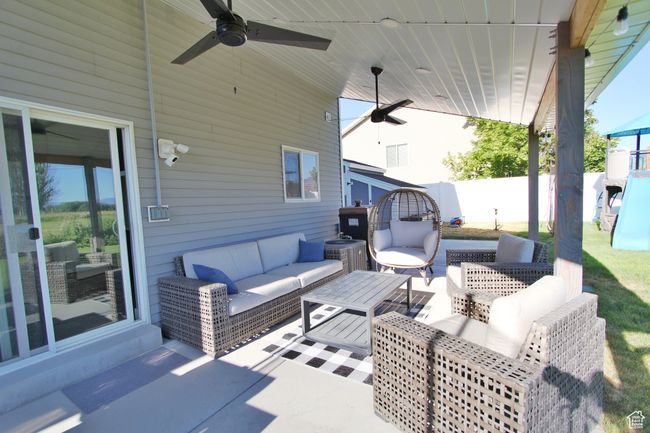 View of patio with an outdoor hangout area and a ceiling fan | Image 22