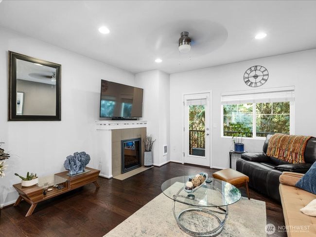 Living Room with cozy fireplace. Windows overlook quiet green space. | Image 5