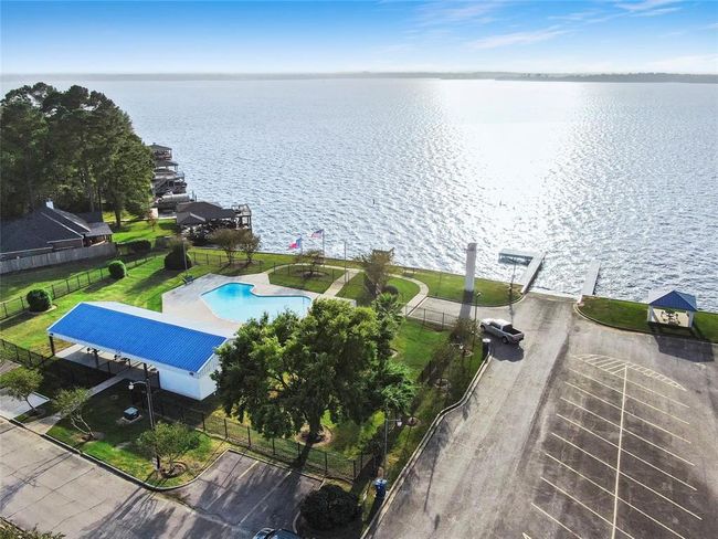 A second boat ramp is conveniently located next to the community pool, right along the scenic shoreline of Lake Conroe. Just across the street, residents can enjoy the community clubhouse and park, offering additional spaces for recreation and gatherings. | Image 49