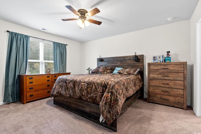 Carpeted bedroom with ceiling fan | Image 16