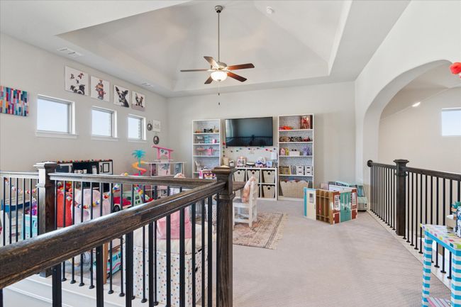 Game room featuring carpet floors, a raised ceiling, visible vents, and a ceiling fan | Image 20