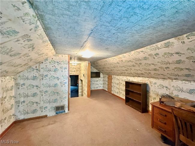 Bonus room with lofted ceiling, wallpapered walls, baseboards, and carpet | Image 19