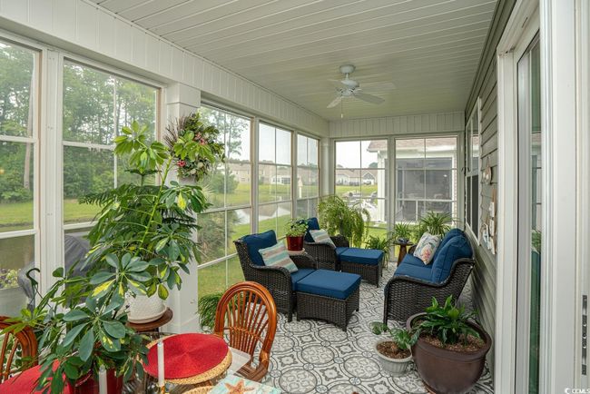 Sunroom / solarium with a ceiling fan | Image 33