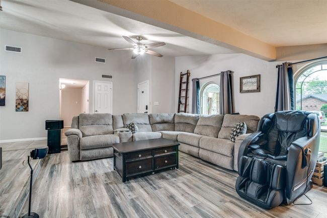 Living room featuring light wood-style floors, ceiling fan, and lofted ceiling | Image 5