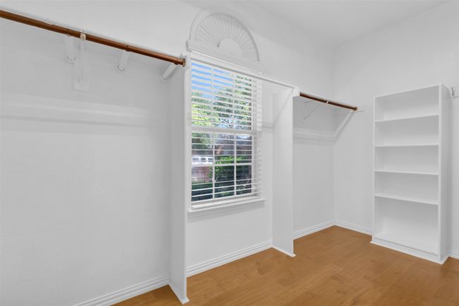 Primary closet with wood finished floors. | Image 18