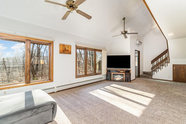 Another view of the great room. Through the far door is the sunroom. The mini-split AC is over the door. The two ceiling fans help circulate the air throughout the rooms. | Image 13