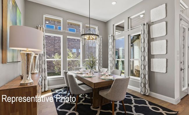 Dining room featuring plenty of natural light, a chandelier, and wood finished floors | Image 6