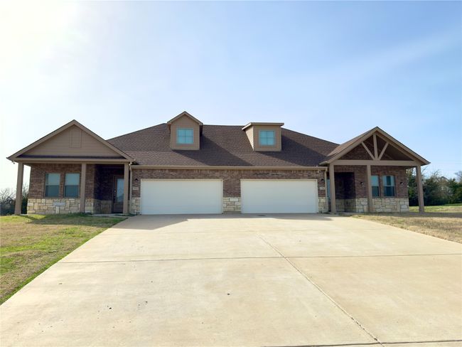 Craftsman inspired home with stone siding, a garage, concrete driveway, roof with shingles, and a front yard | Image 17