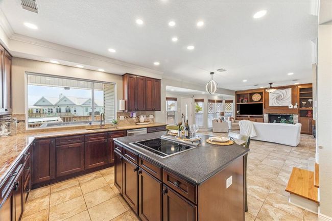 Experience convenience in this modern kitchen with slide-out shelves, offering easy access to lower storage without bending. | Image 18