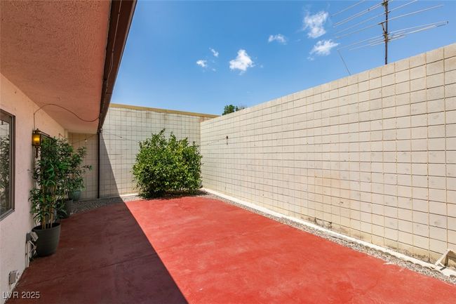 Fenced backyard with a patio area | Image 42