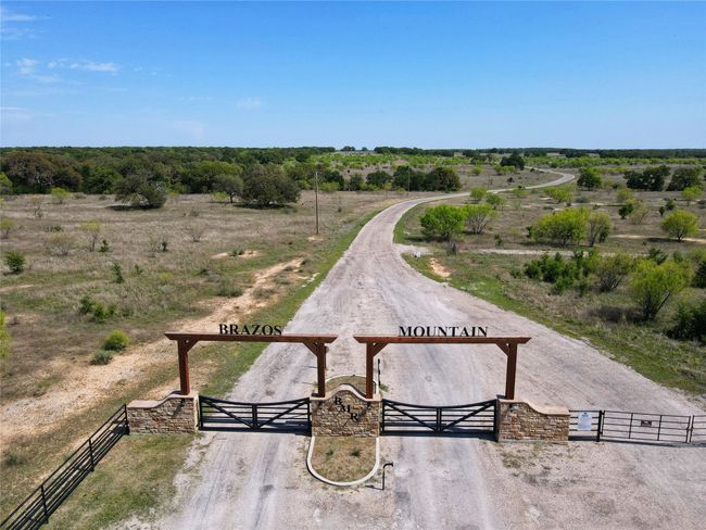 View of community featuring a rural view, fence, and a gate | Image 8