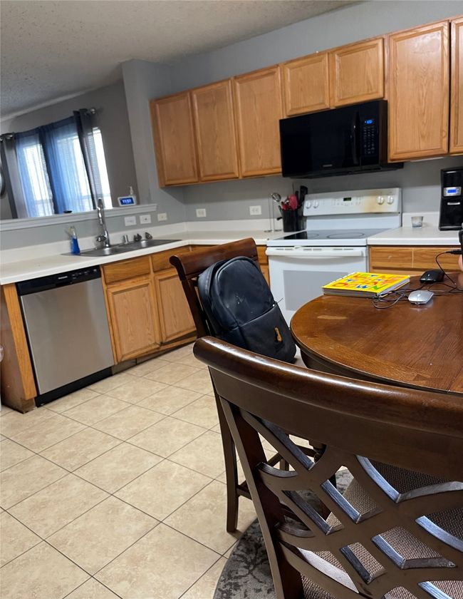 Kitchen with dishwasher, microwave, electric range, light countertops | Image 7