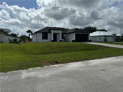 View of front of property with a garage and a front yard | Image 2