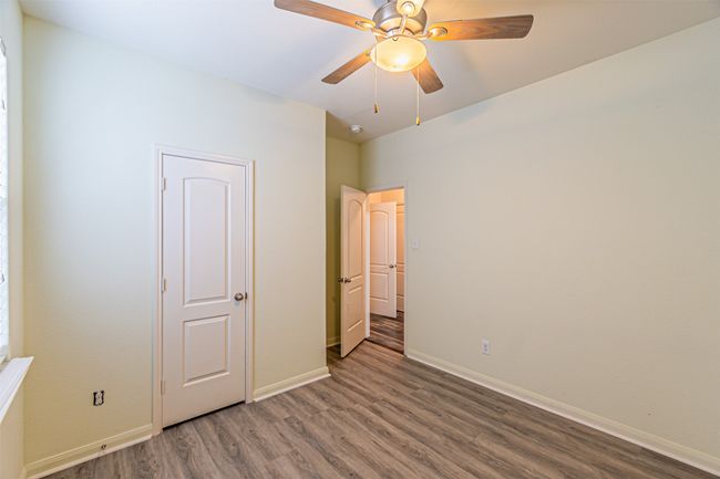 Unfurnished bedroom featuring wood finished floors, baseboards, and a ceiling fan | Image 24