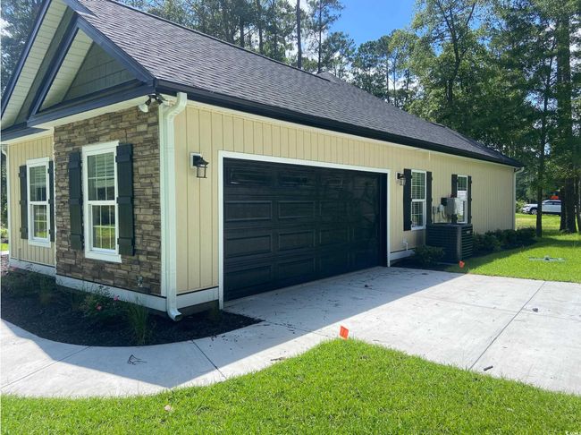 Garage featuring concrete driveway | Image 4