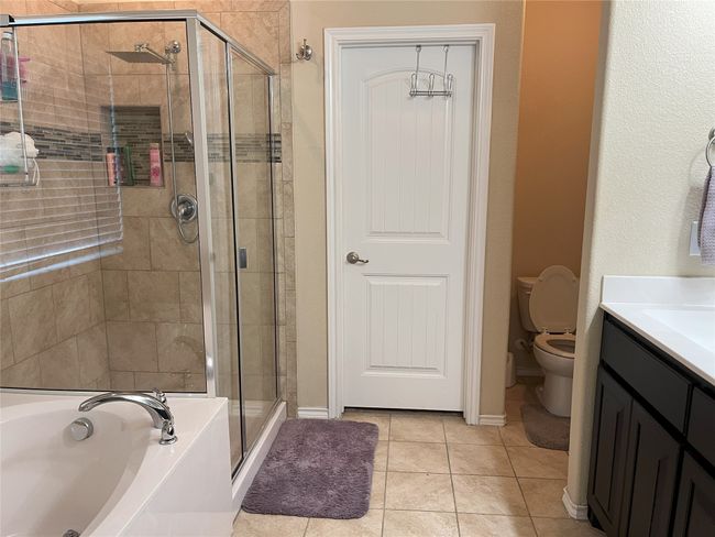 Full bathroom with vanity, tile patterned floors, toilet, and separate shower and tub | Image 11