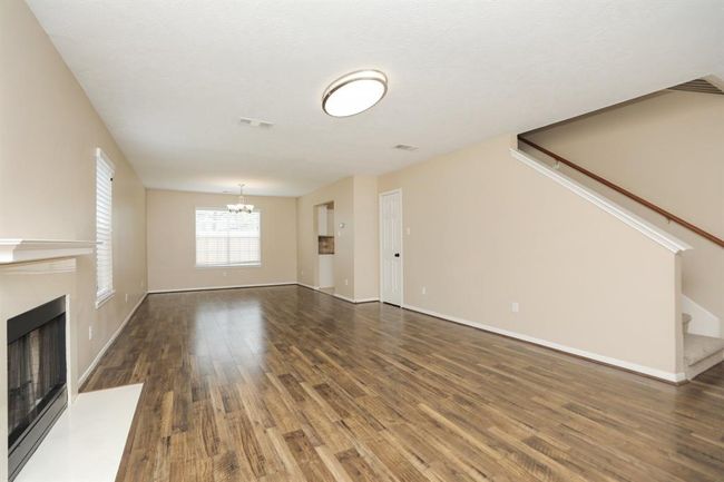 Livin/dining combo downstairs with recent flooring and fresh paint. | Image 7