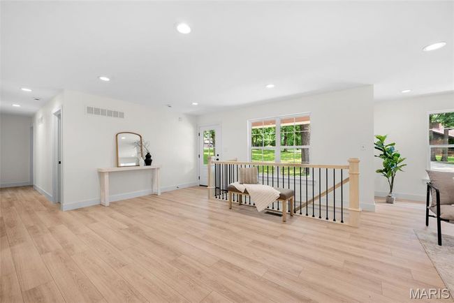 Sitting room featuring an upstairs landing, light wood finished floors, and recessed lighting | Image 6