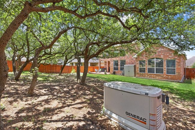 The only thing that provides more comfort than this quiet back yard with mature trees - is a backup generator that will keep your home running during emergency power outages. | Image 36