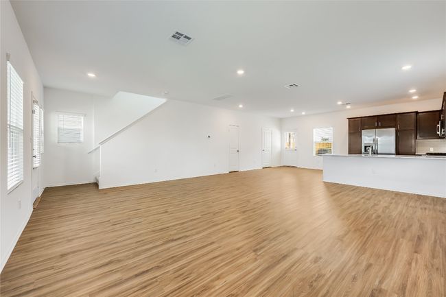 Unfurnished living room with light wood-type flooring and recessed lighting | Image 4