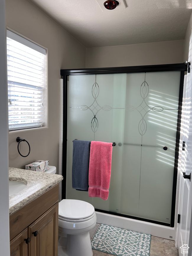 Bathroom with vanity, a shower stall, and tile patterned flooring | Image 60
