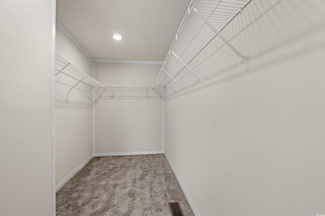 Spacious closet with carpet and visible vents | Image 17