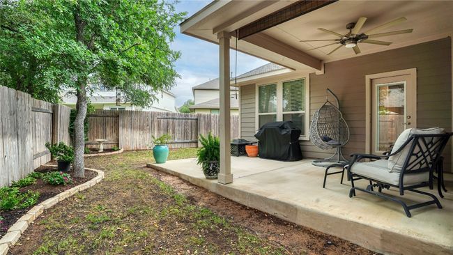View of patio featuring a fenced backyard and ceiling fan | Image 31
