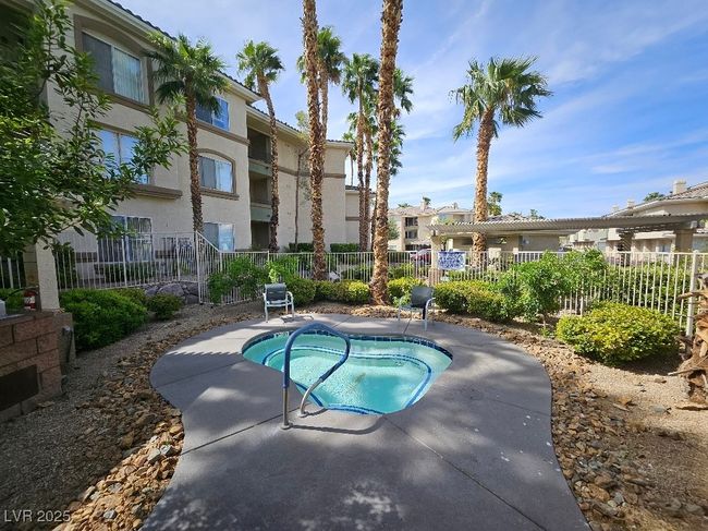 View of pool with fence and a hot tub | Image 7