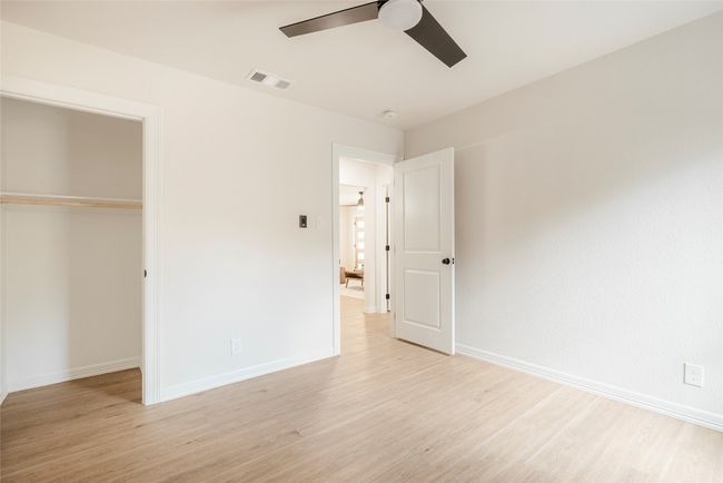 Unfurnished bedroom featuring light wood-style flooring, a closet, and a ceiling fan | Image 26