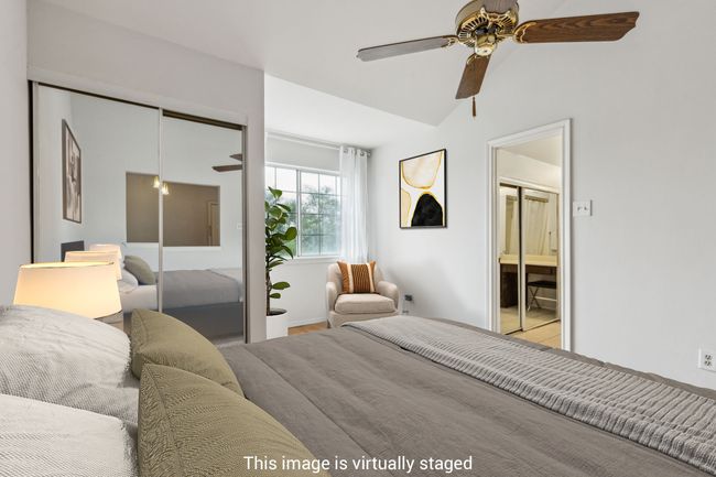 Bedroom with a closet, a ceiling fan, connected bathroom, baseboards, and lofted ceiling | Image 4