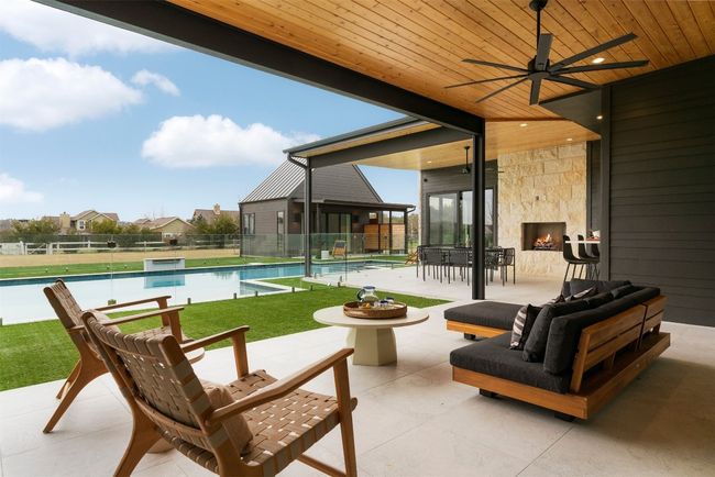 Beyond the walls, an expansive covered porch with automatic sunshades extends into a resort-style retreat | Image 28