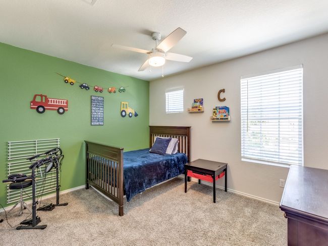Carpeted bedroom with baseboards and a ceiling fan | Image 25