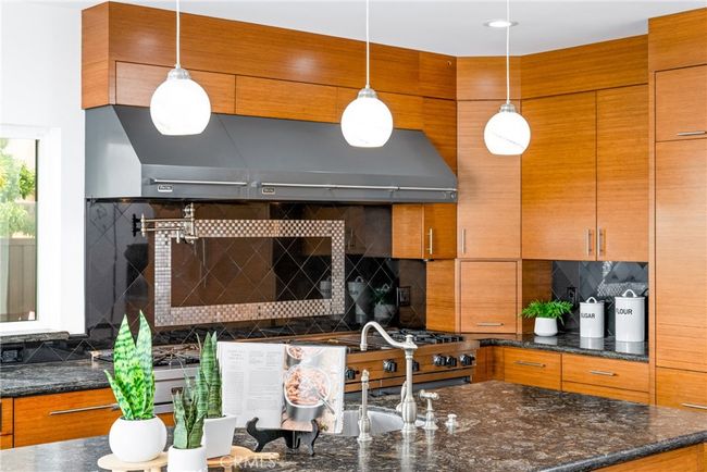 The list go's on with multiple dishwashers, a wine and sub-zero fridge, and a mosaic tile backsplash. | Image 15