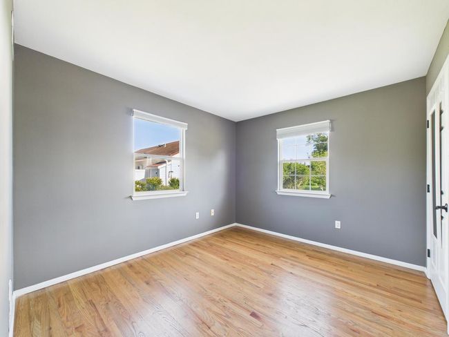 Spare room featuring baseboards and wood finished floors | Image 24