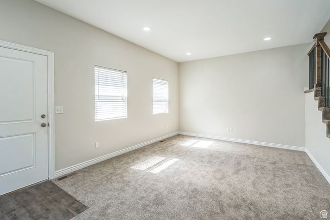 Unfurnished living room featuring stairs, carpet, and recessed lighting | Image 24