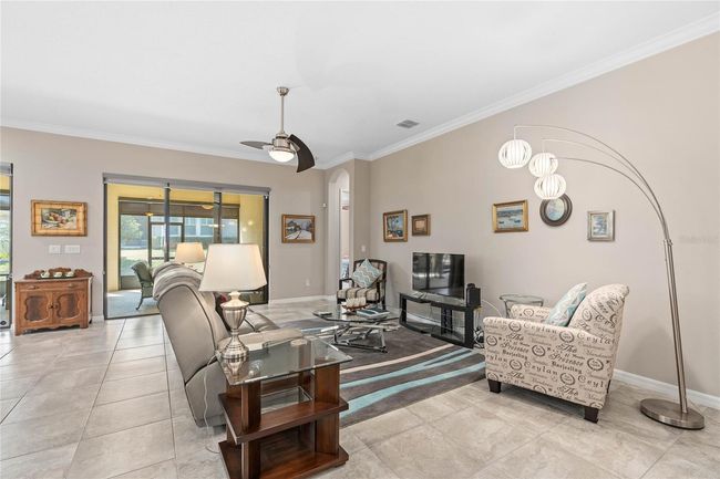 Family Room with a view of the Extended Under Roof Lanai with an Outdoor Kitchen | Image 15
