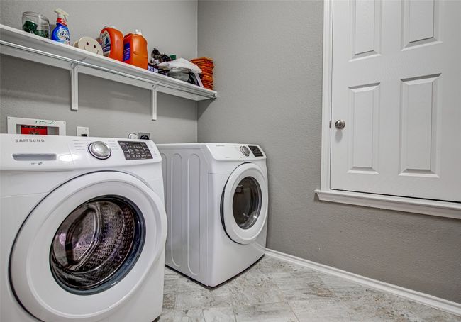 Laundry area with separate washer and dryer, baseboards, and laundry area | Image 16