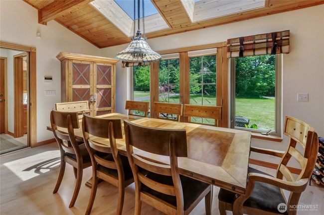Large dining area with more windows and skylights, allowing for lots of natural light. | Image 10