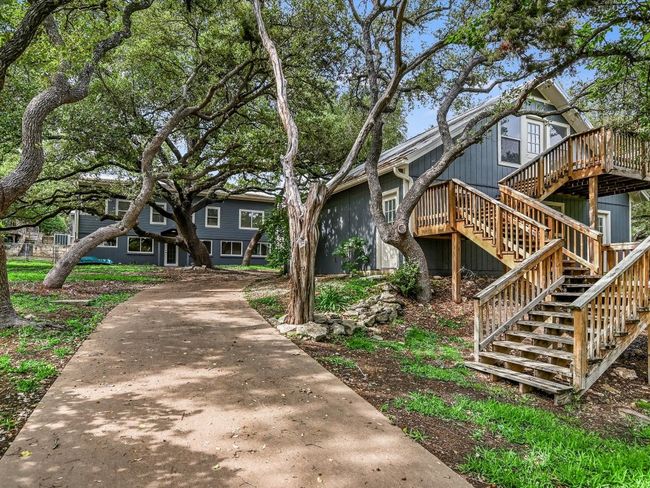 View of front of property with driveway, stairway, and a wooden deck | Image 22