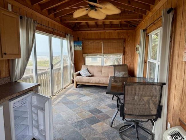Sunroom with a ceiling fan and beamed ceiling | Image 16