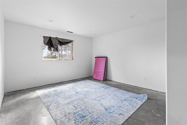 Empty room with visible vents and unfinished concrete floors | Image 47